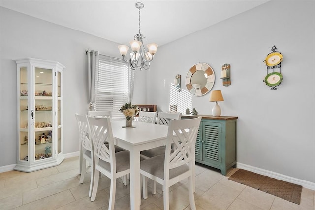 tiled dining space with a chandelier