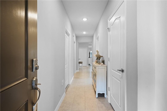 corridor with light tile patterned floors