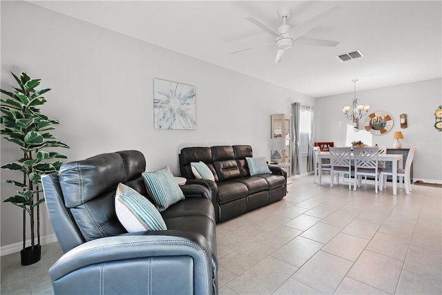 tiled living room with ceiling fan with notable chandelier