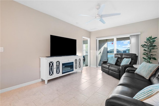 living room with ceiling fan and light tile patterned flooring