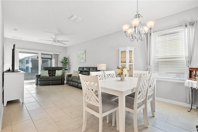 dining room featuring ceiling fan with notable chandelier and light tile patterned flooring