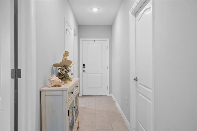 hall featuring light tile patterned flooring