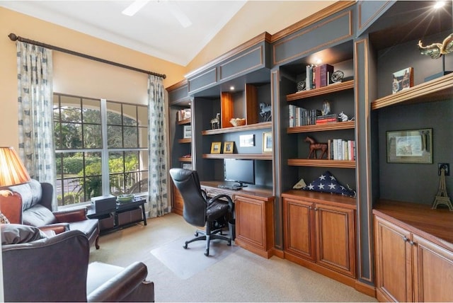 carpeted home office featuring vaulted ceiling