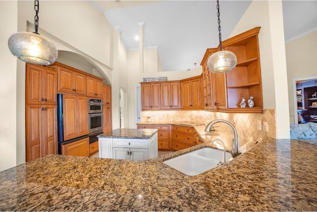 kitchen with kitchen peninsula, decorative backsplash, sink, pendant lighting, and high vaulted ceiling