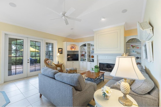 living room featuring ceiling fan, light tile patterned floors, ornamental molding, and french doors