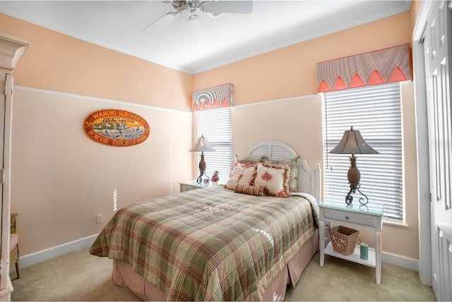 bedroom featuring ceiling fan, light colored carpet, and crown molding