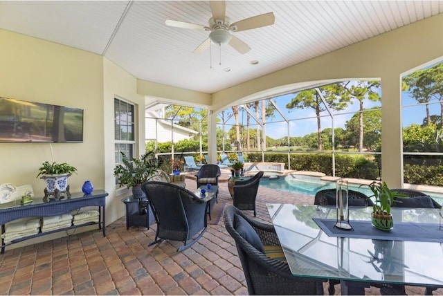 sunroom featuring ceiling fan