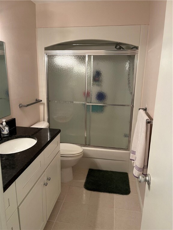 bathroom featuring vanity, tile patterned flooring, and toilet