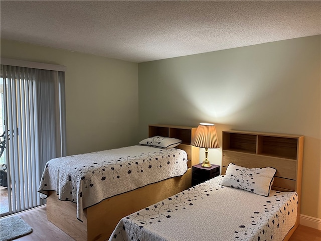 bedroom featuring wood-type flooring and a textured ceiling