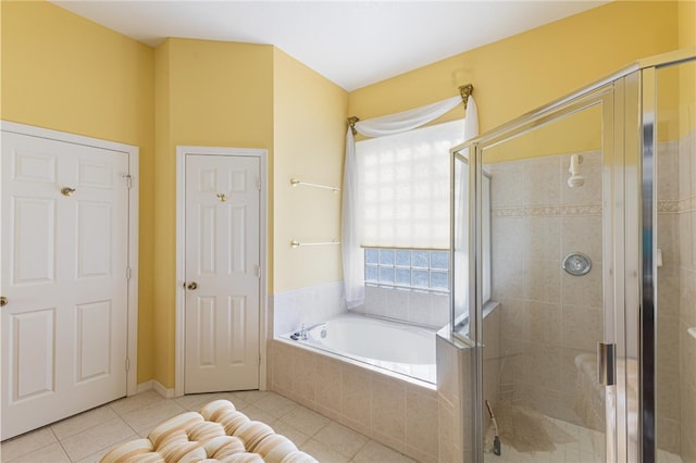 bathroom featuring tile patterned flooring and shower with separate bathtub