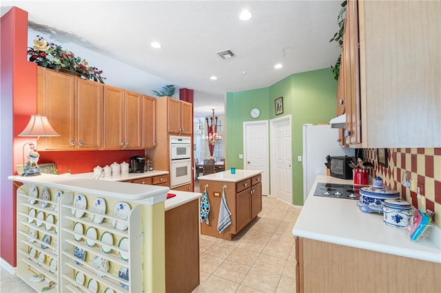 kitchen with a center island, light tile patterned floors, white double oven, kitchen peninsula, and black electric stovetop