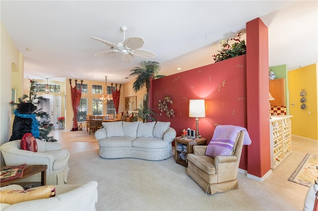 carpeted living room featuring ceiling fan with notable chandelier