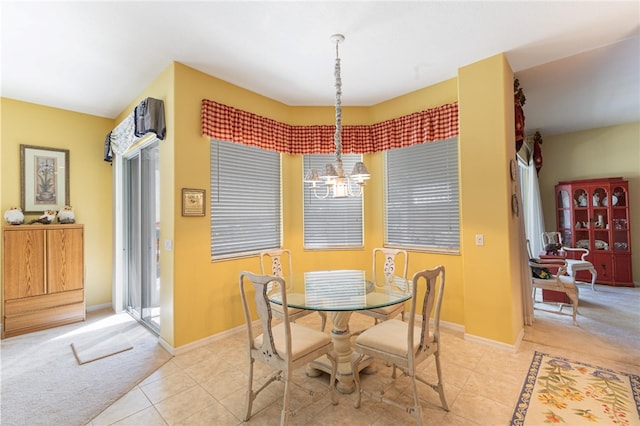 carpeted dining space with a notable chandelier