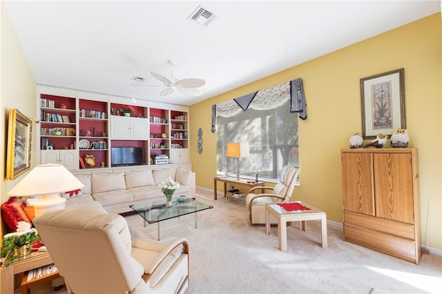 carpeted living room with ceiling fan