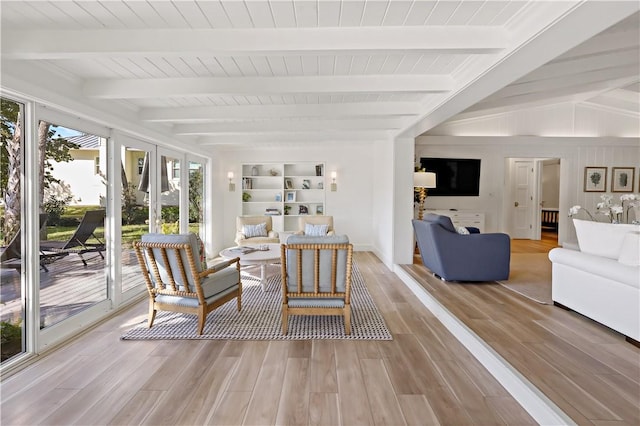 interior space with hardwood / wood-style flooring, built in shelves, french doors, and beamed ceiling