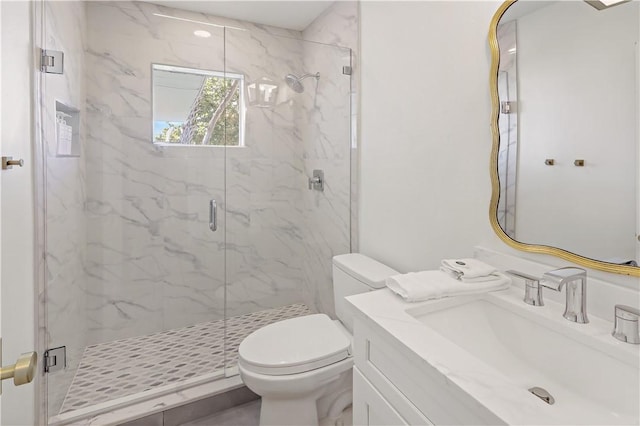 bathroom with walk in shower, vanity, and toilet