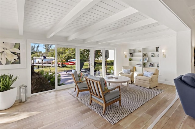 sunroom featuring french doors and beamed ceiling