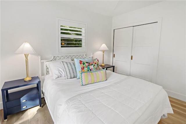 bedroom featuring light wood-type flooring and a closet