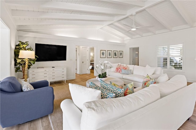 living room with ceiling fan, lofted ceiling with beams, and hardwood / wood-style flooring