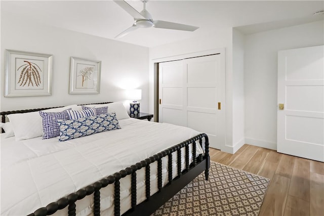 bedroom with a closet, ceiling fan, and light wood-type flooring