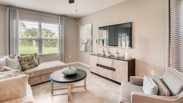 tiled living room with ceiling fan