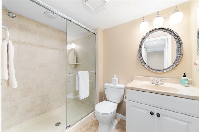 bathroom featuring vanity, toilet, and an enclosed shower