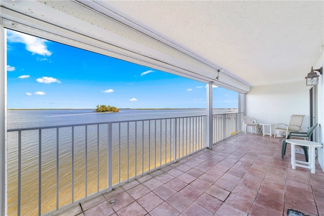 exterior space with a water view and a balcony