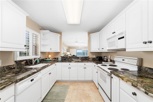 kitchen featuring white cabinetry, sink, ceiling fan, dark stone counters, and white appliances