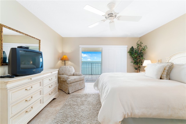 tiled bedroom with ceiling fan and access to outside