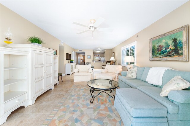 living room with ceiling fan and light tile patterned flooring