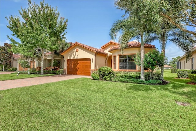 mediterranean / spanish-style home featuring a garage and a front yard