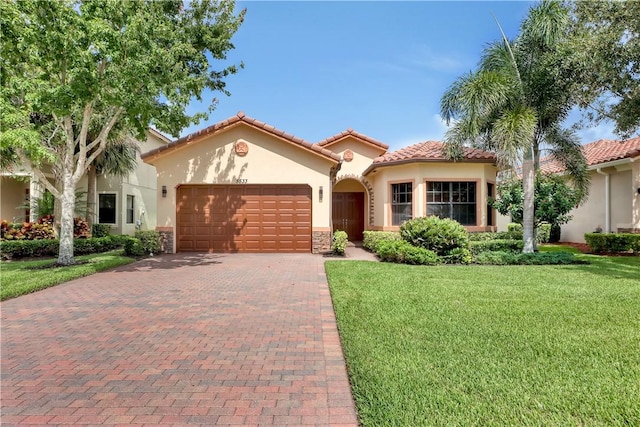 mediterranean / spanish-style house featuring a front lawn and a garage