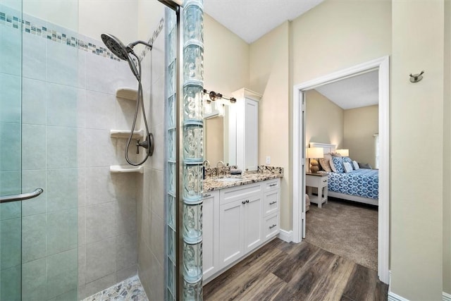 1335 Winding Oaks Cir E Unit 1007, Vero Beach, FL 32963 - bathroom with a tile shower, wood finished floors, connected bathroom, vanity, and baseboards