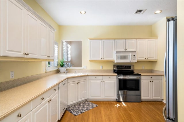 kitchen with white cabinetry and appliances with stainless steel finishes