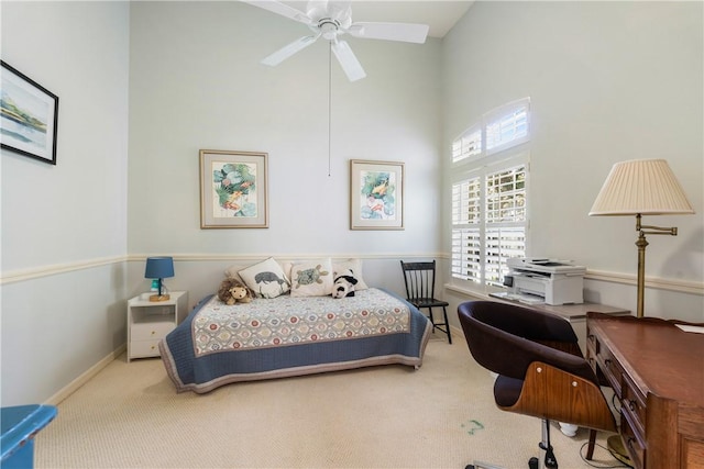 carpeted bedroom with a towering ceiling