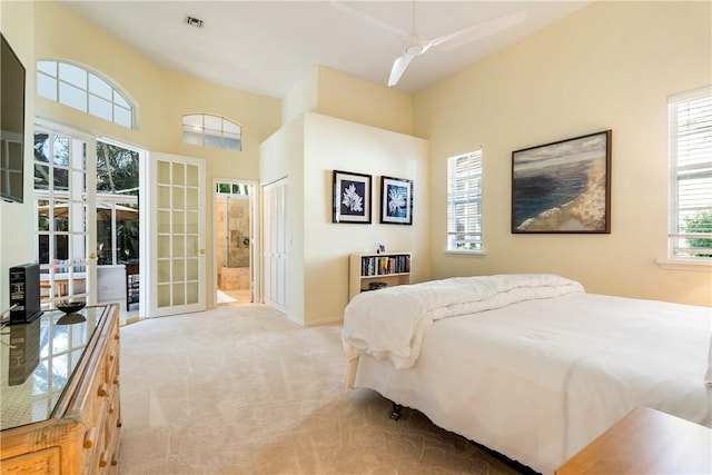 bedroom with light carpet, access to exterior, french doors, and ceiling fan