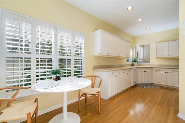 kitchen featuring white cabinetry, dishwasher, and light hardwood / wood-style floors