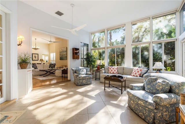 sunroom / solarium with ceiling fan with notable chandelier