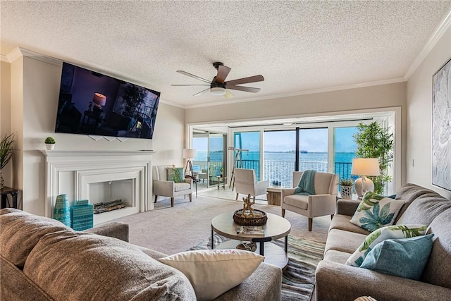 living room featuring carpet flooring, ceiling fan, crown molding, and a textured ceiling