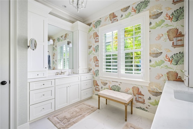 bathroom featuring wallpapered walls, baseboards, ornamental molding, marble finish floor, and vanity