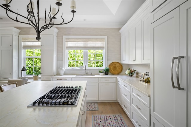 kitchen with a sink, white cabinets, and stainless steel gas stovetop