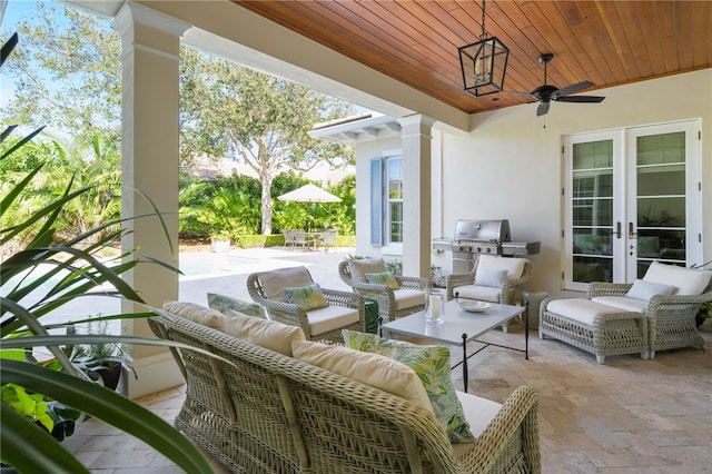 view of patio featuring outdoor dining area, an outdoor hangout area, a ceiling fan, and french doors