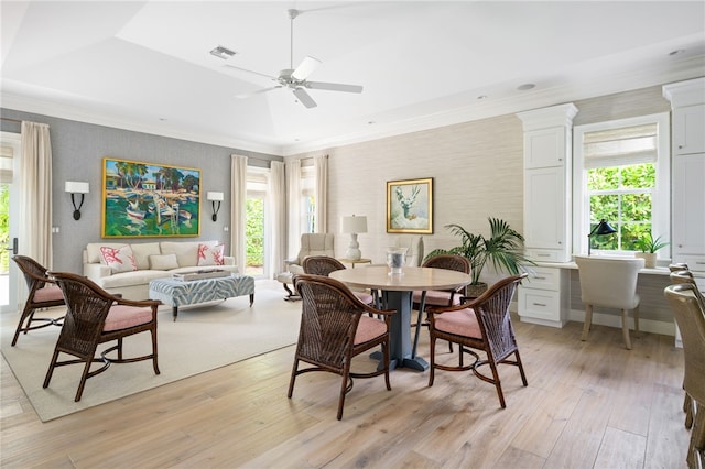 dining room with ceiling fan, wallpapered walls, light wood-type flooring, and crown molding