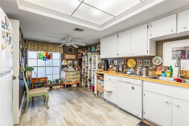 kitchen featuring sink, white appliances, light hardwood / wood-style flooring, ceiling fan, and white cabinets