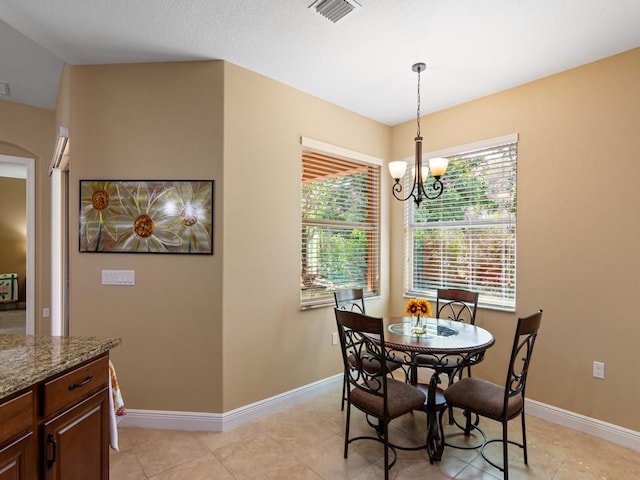 dining area featuring an inviting chandelier and light tile patterned floors