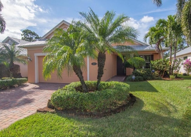 view of front of house with a garage and a front yard