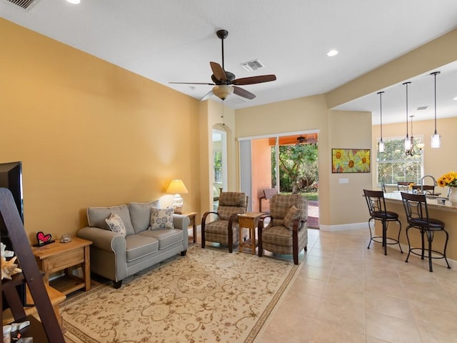 living room featuring light tile patterned floors and ceiling fan