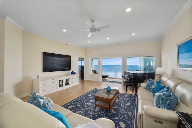 living room featuring crown molding, ceiling fan, and light hardwood / wood-style flooring