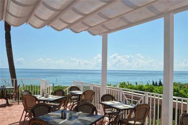 exterior space with a water view and a patio