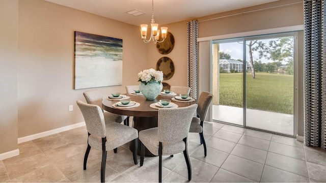 dining area featuring a chandelier and light tile patterned floors